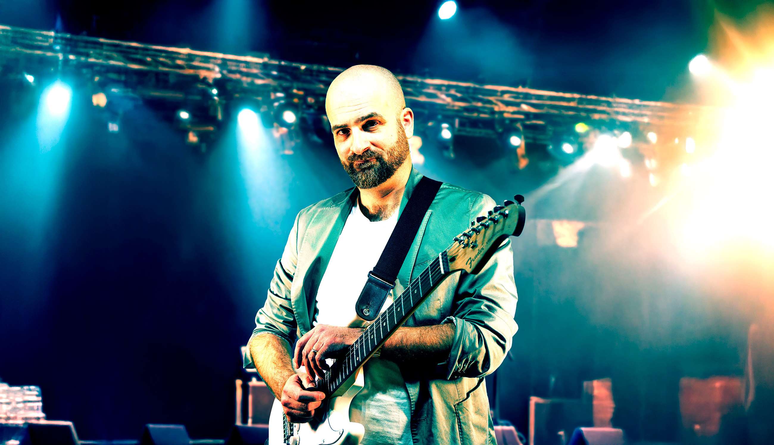 Chris Strobel on stage with an electric guitar
